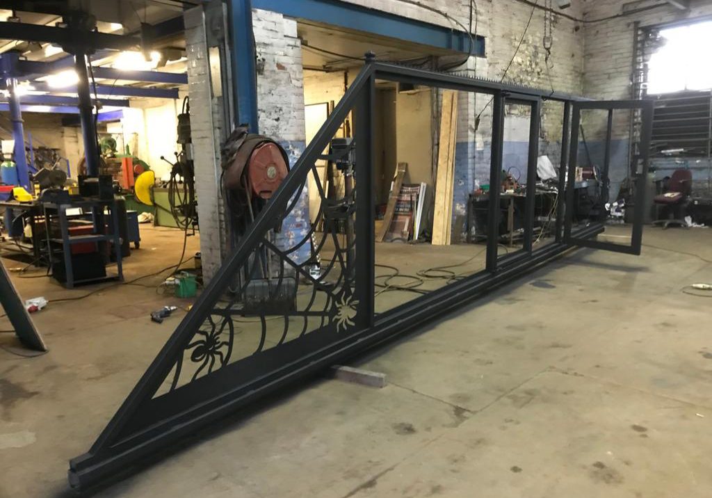 Iron gate with spider detail in a workshop